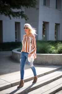 fall off the shoulder top / ripped denim jeans / crossbody bag / brown suede booties