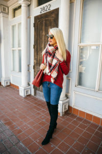 christmas plaid blanket scarf, red leather bag with chain strap, black suede over the knee boots, medium wash skinny jeans, ribbed red sweater, lace up back sweaters