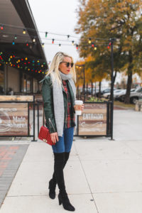red and green plaid button down, hunter green leather jacket, black suede over the knee boots, red leather crossbody bag, medium wash skinny jeans