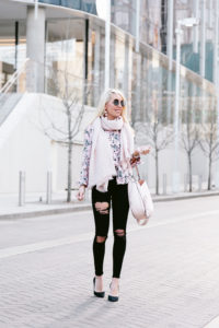 light pink statement earrings, silk button down floral blouse, black skinny jeans with rips