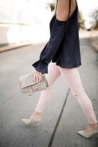 blush skinny jeans, pink jeans for spring, tan suede clutch