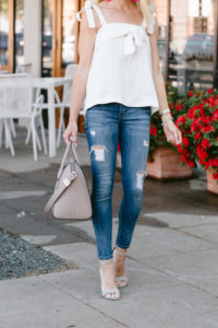 large taupe satchel, distressed skinny jeans, summer suede sandals, white linen top