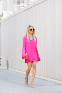 bell sleeved pink dress, fuchsia shift dress, multi strand turquoise necklace, open toe tan heels