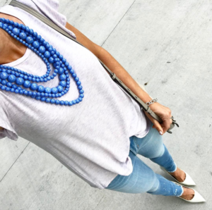 blue statement necklace - skinny distressed hem jeans, white closed toe stilletos, lavender butterfly sleeve top