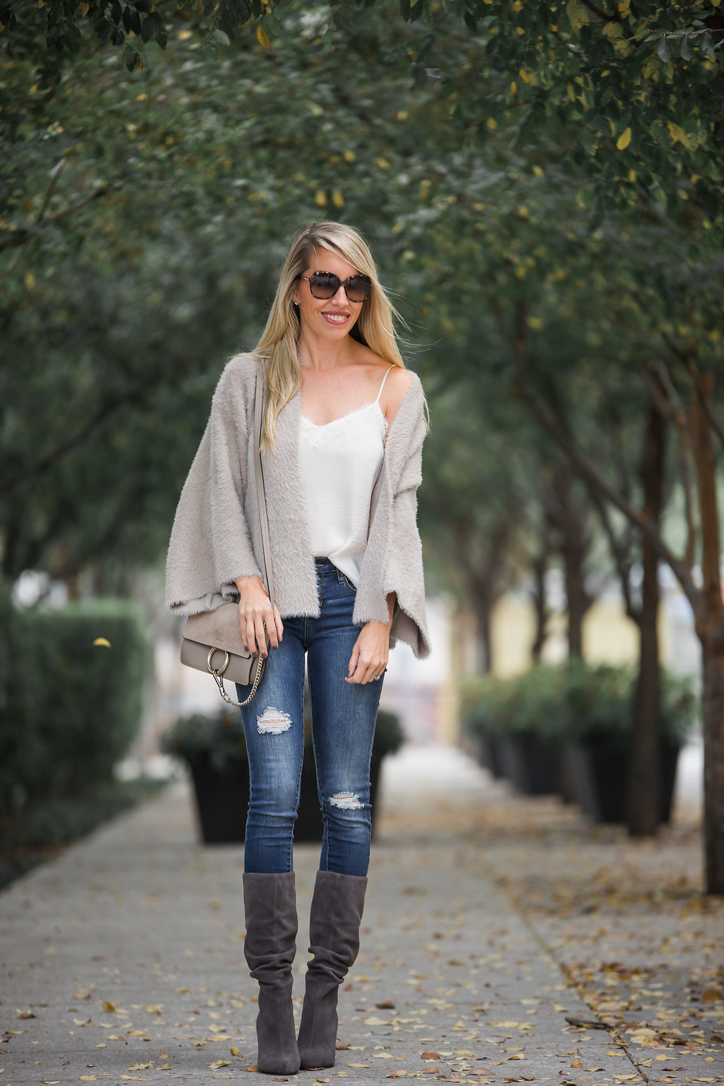 cozy neutral cardigan worn with grey suede boot and a lace cami