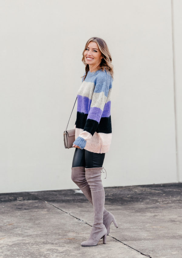 Colorblock sweater paired with faux leather leggings and OTK boots