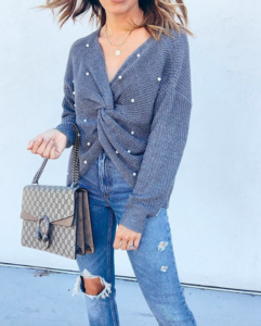 dallas fashion blogger wearing amazon fashion pearl criss cross sweater with abercrombie ripped high rise mom jeans
