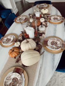 lifestyle blogger decorating formal dining room for thanksgiving table