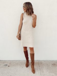 fashion blogger wearing oatmeal sleeveless mock neck sweater dress with tall suede brown boots