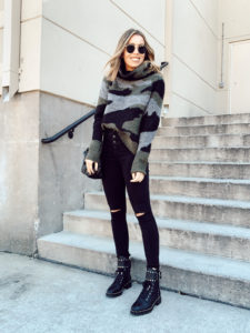 casual fall winter cold weather style camo sweater with black jeggings and studded combat buckle booties