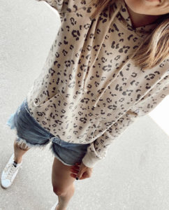 leopard print pullover hoodie with agolde parker denim cutoff shorts and golden goose sneakers