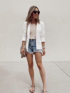 fashion blogger wearing white blazer and cutoff jean shorts outfit