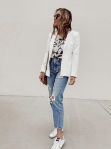 fashion blogger wearing white blazer with graphic tee and distressed jeans