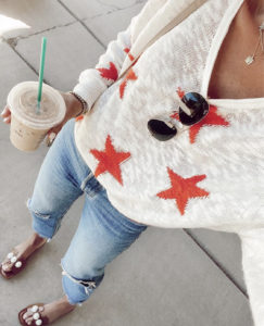 fashion blogger wearing 4th of july star print sweater for summer