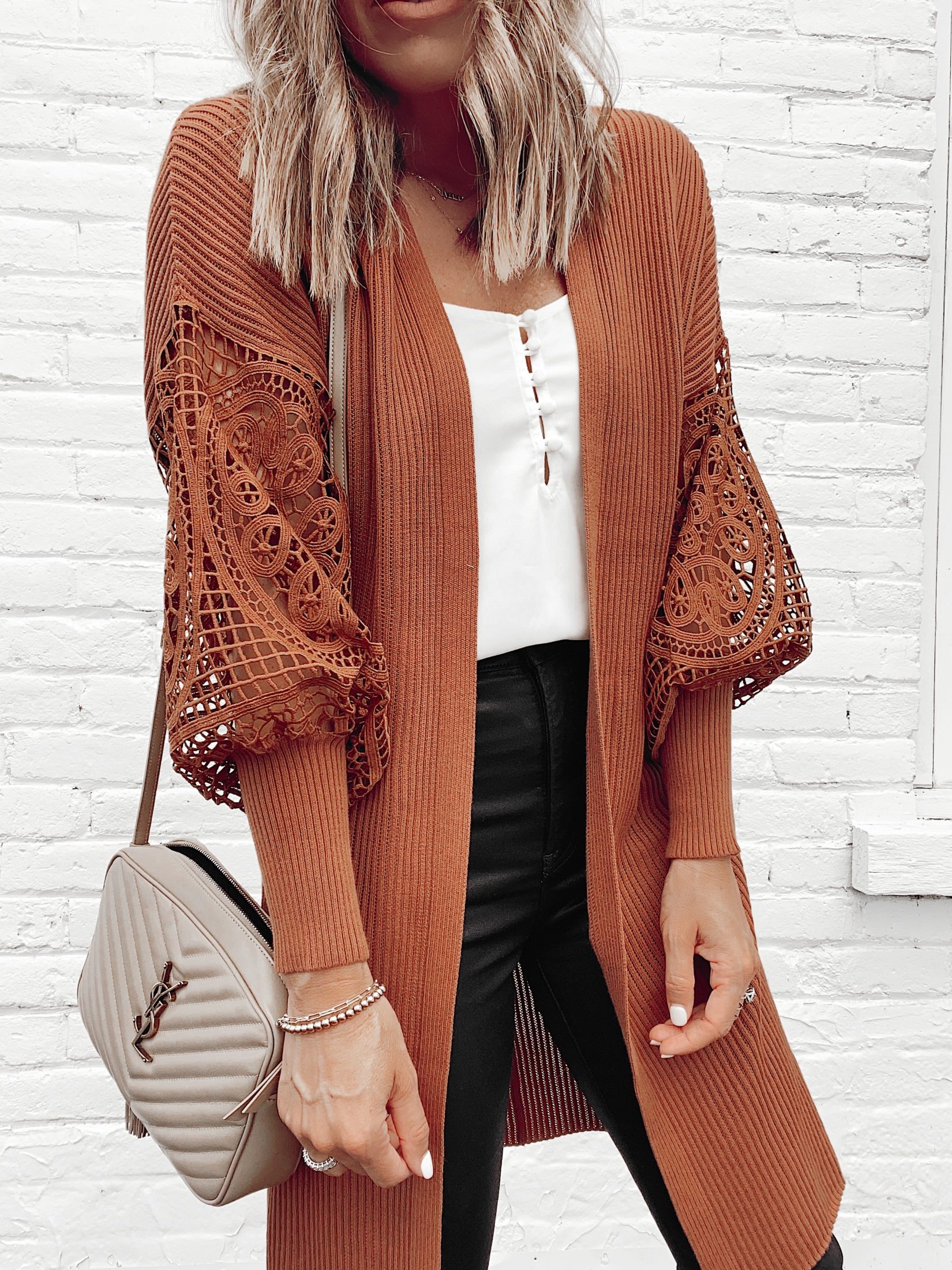 fashion blogger wearing express burnt sienna lace balloon sleeve cardigan with black coated skinny jeans