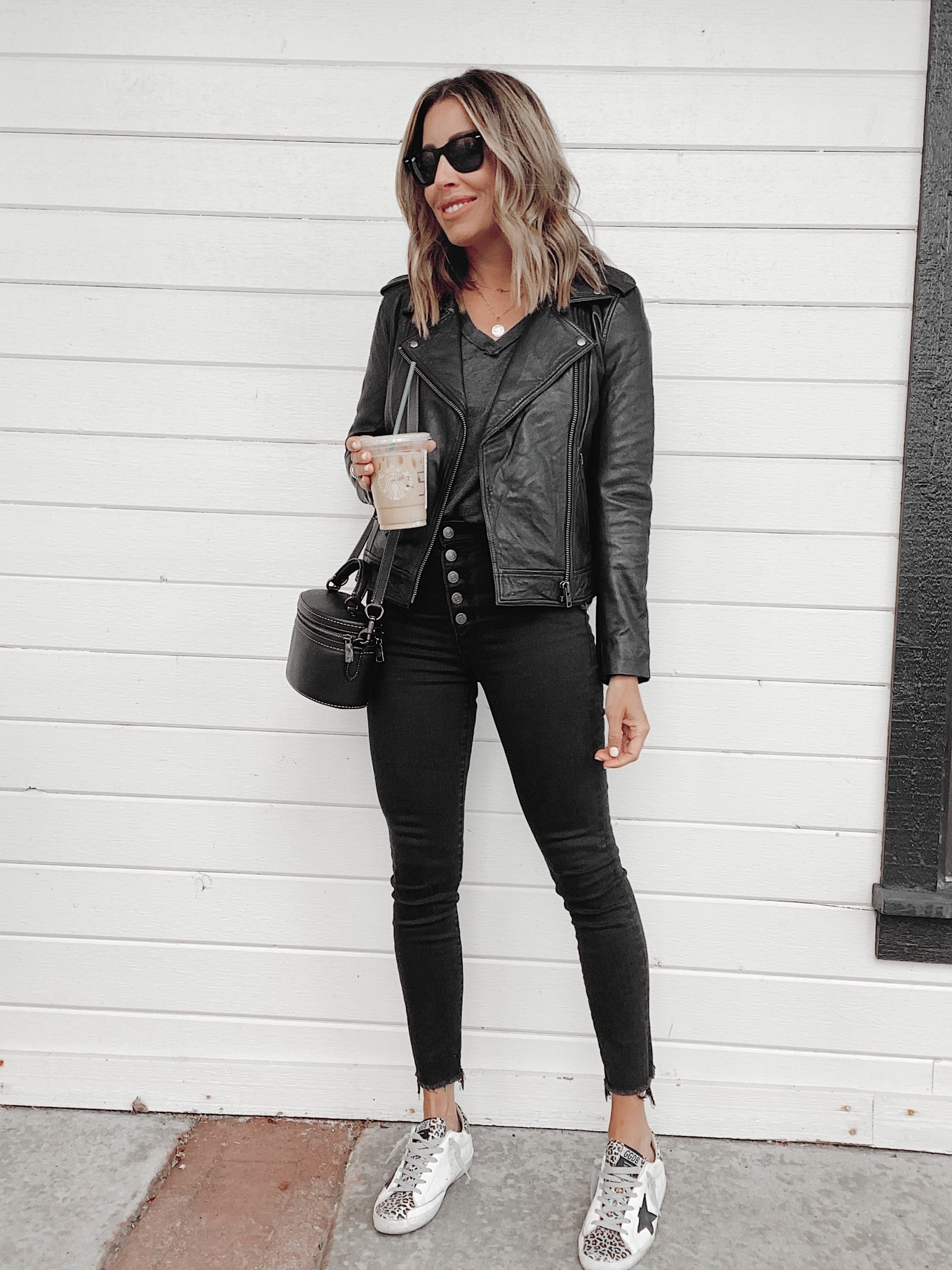 jaime shrayber styling black faux leather biker jacket with black jeans for fall 2020