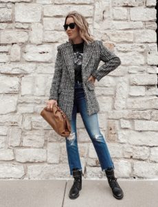 fashion blogger wearing graphic tee with plaid blazer and jeans with combat boots